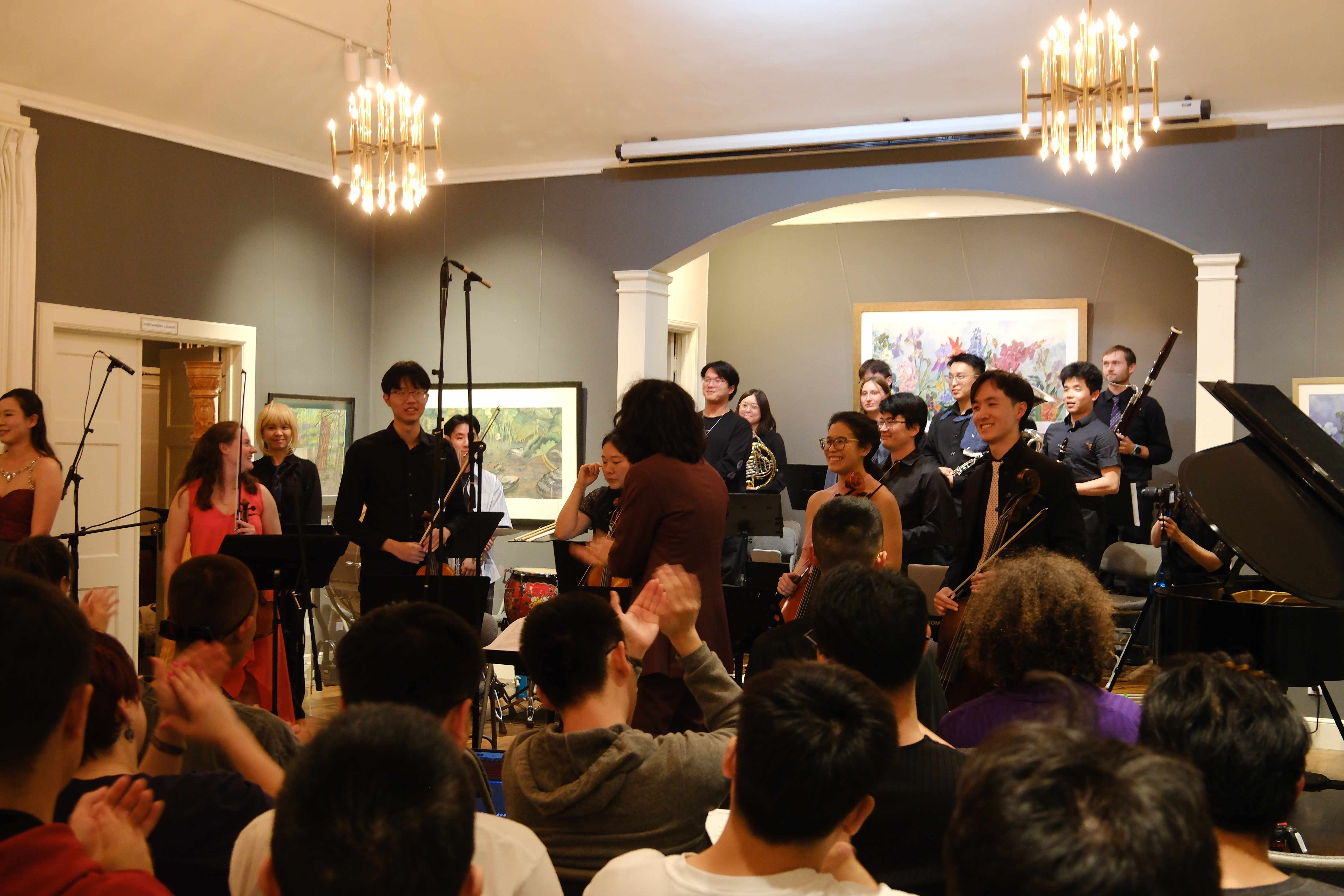 Ensemble taking bow with applause from audience