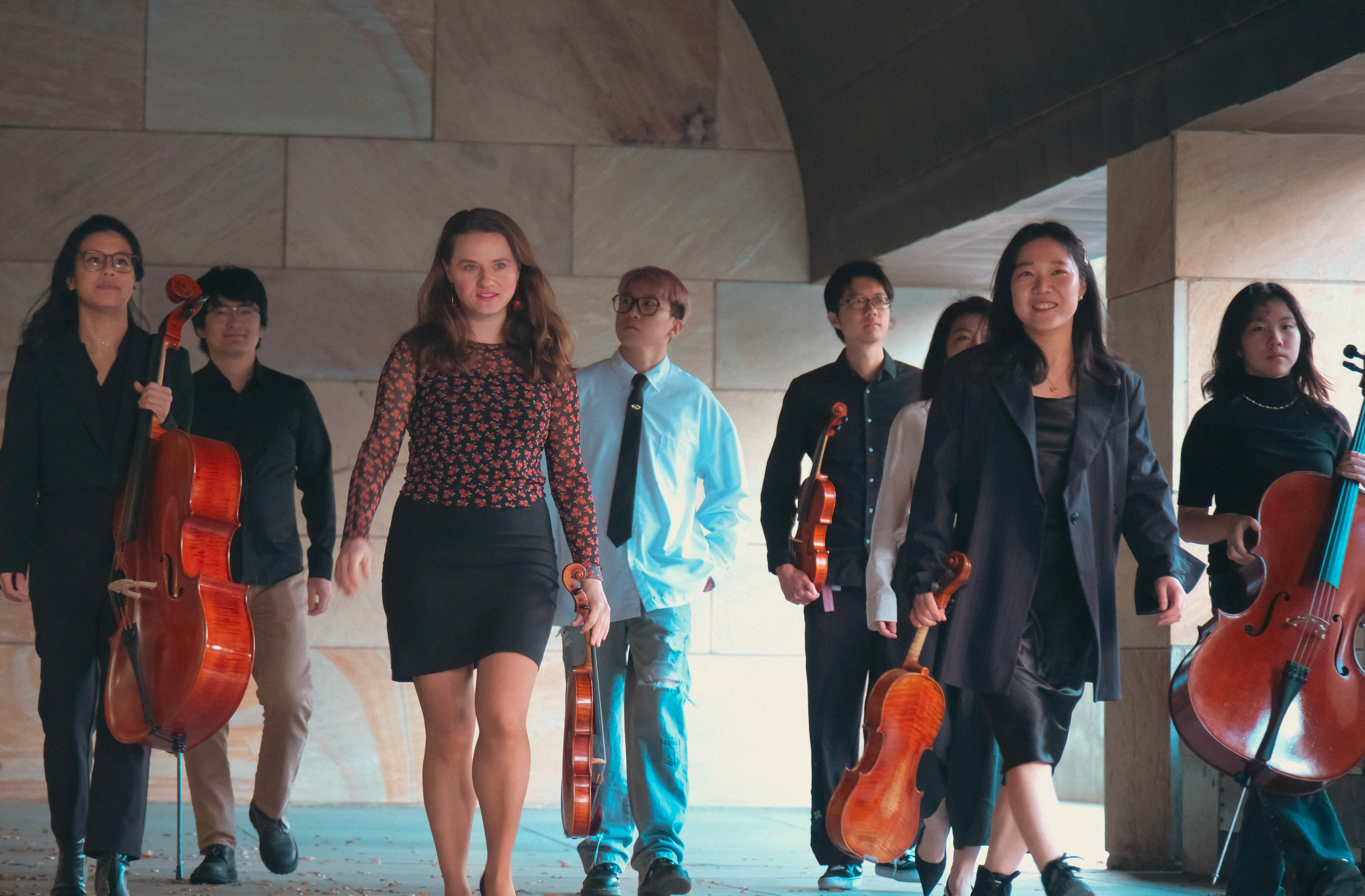 Orchestra musicians walking with instruments